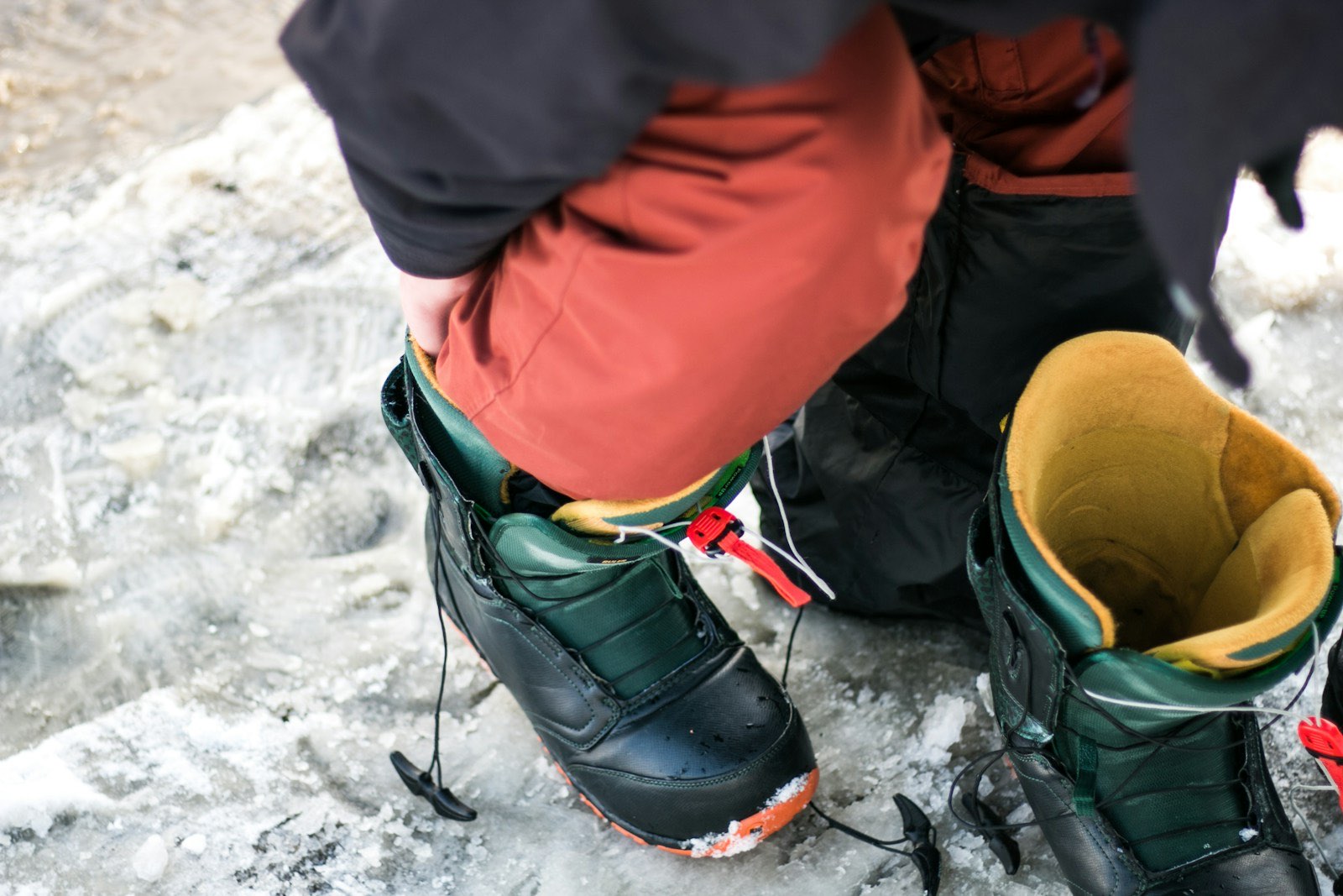 Skier pulling on a snow boot, close up of hands and liner (stock placeholder)